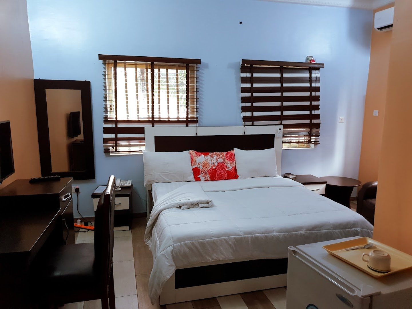 Comfortable guest room with bed, AC, and modern furnishings